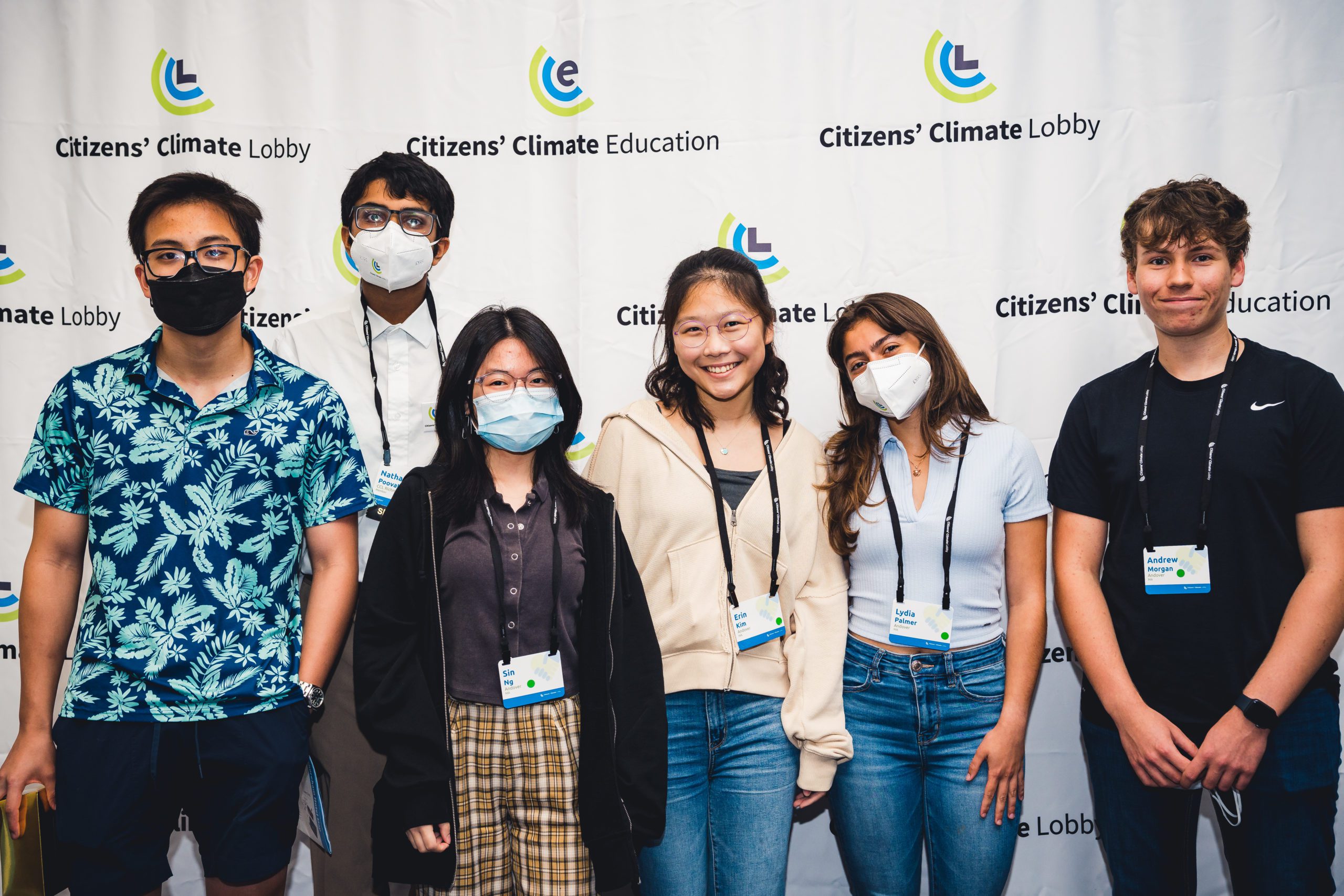 A group of youth standing in front of a Citizens' Climate Education and Citizens' Climate Lobby Backdrop